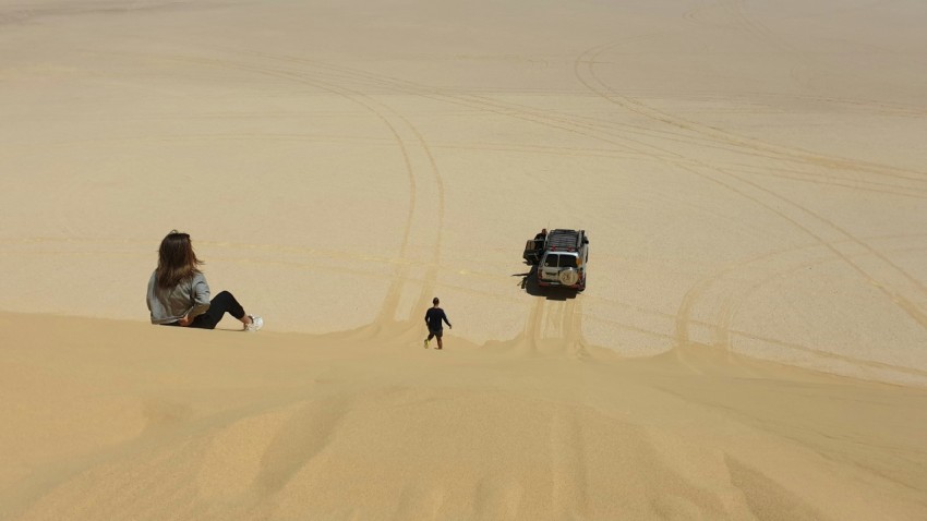 white suv on desert during daytime