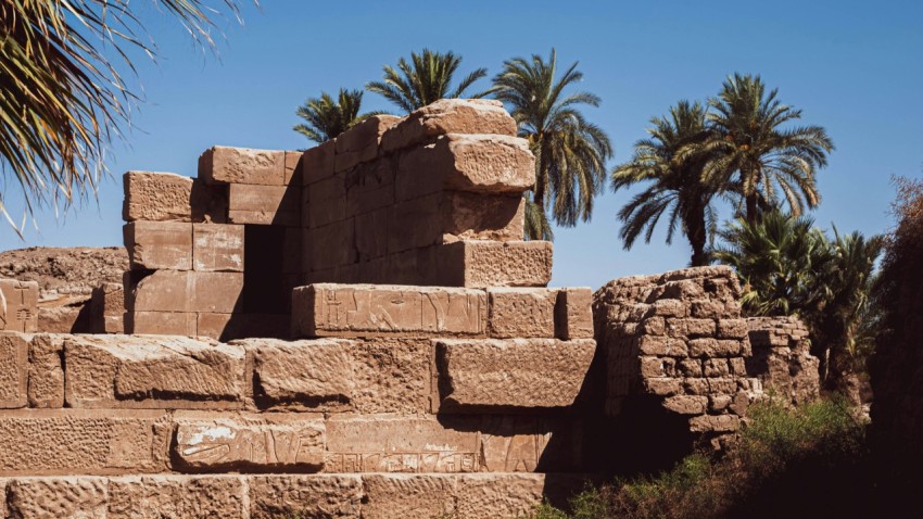 a stone structure with trees in the background