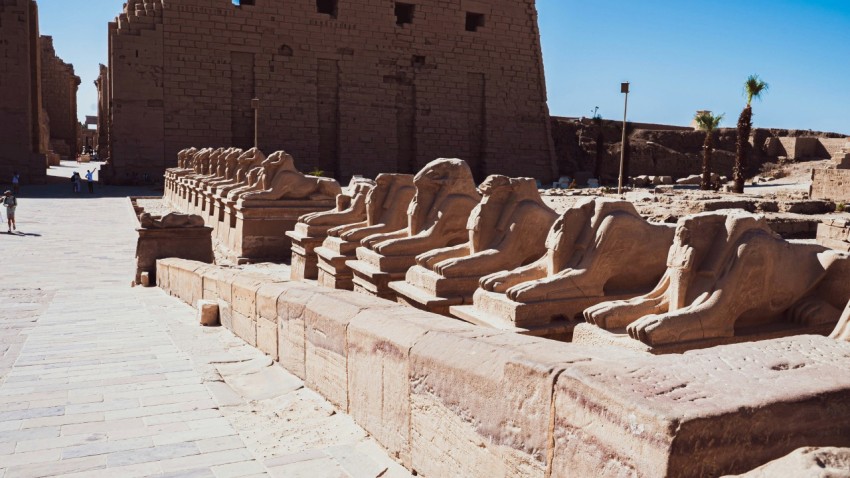 a stone wall with a group of statues on it