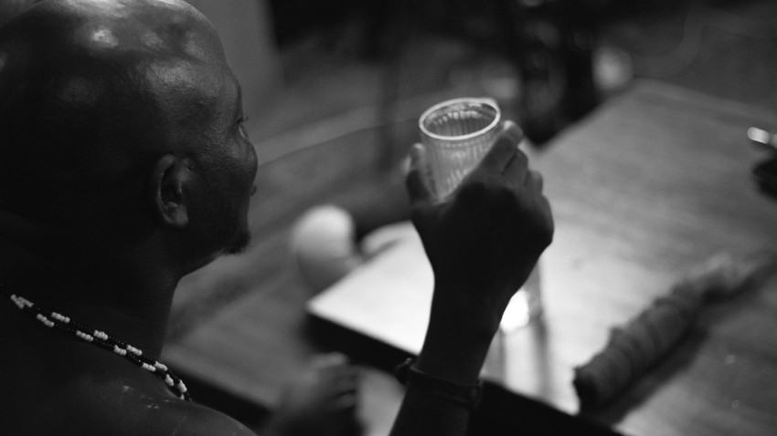 a man holding a cup of coffee up to his face