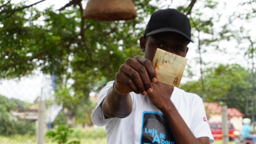 man holding 50 banknote