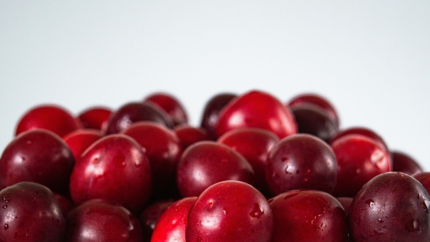 a bunch of plums sitting on top of each other