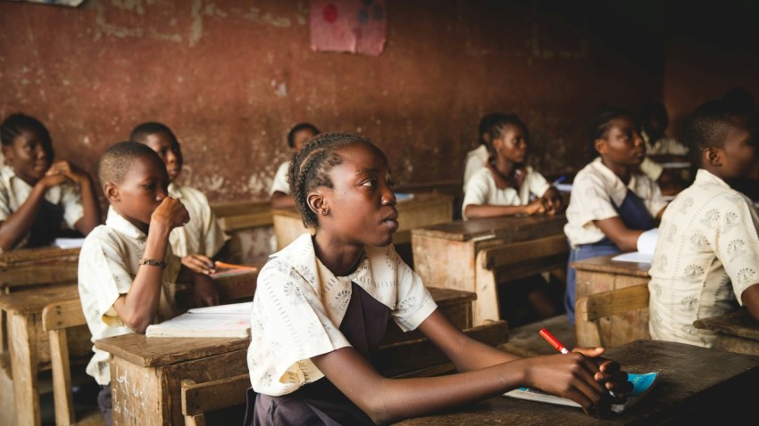 children sitting on chairs inside classroom