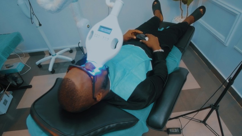 a man laying on a chair in a dentists office