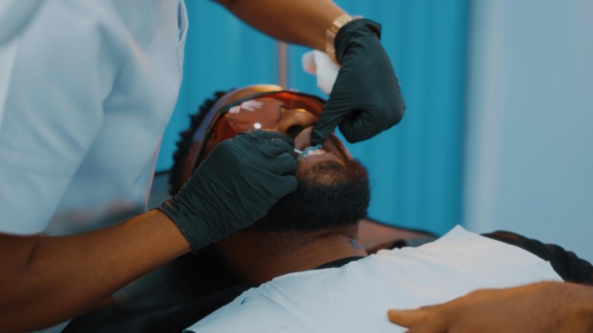 a man getting his teeth checked by a dentist