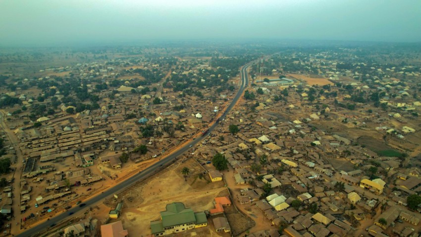 an aerial view of a village and a road