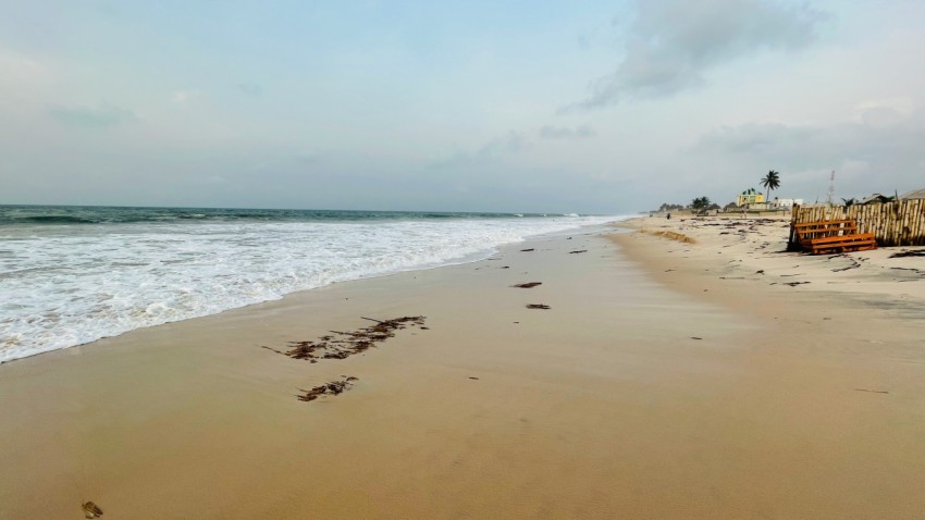 a sandy beach with waves coming in to shore