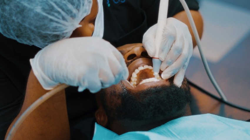 a man getting his teeth checked by a dentist