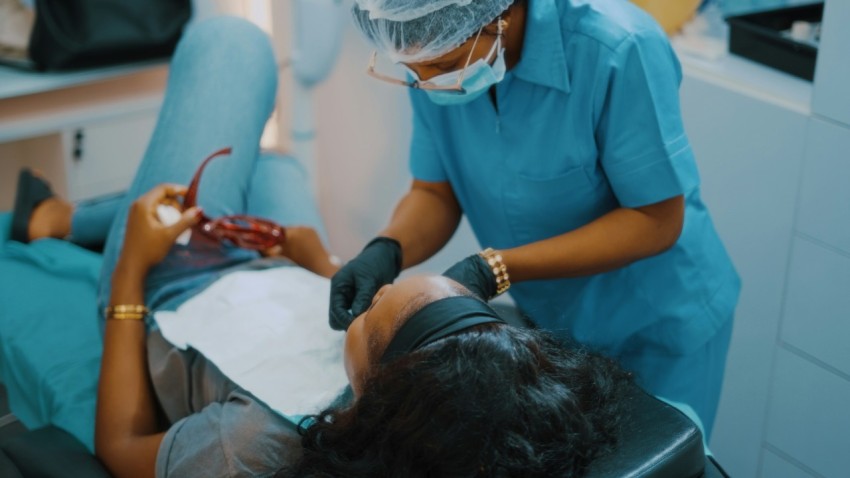 a woman getting her teeth checked by a dentist