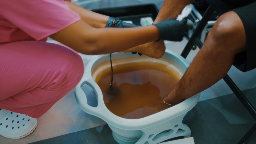 a person in a pink shirt is putting something in a bucket