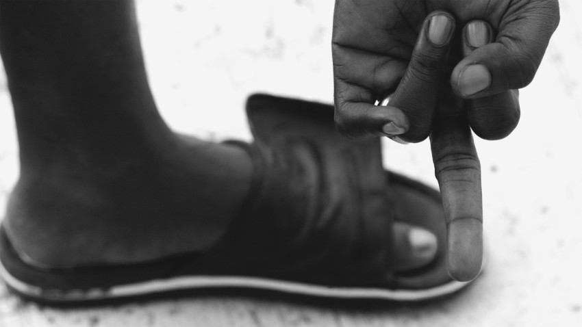 a black and white photo of a person pointing at something