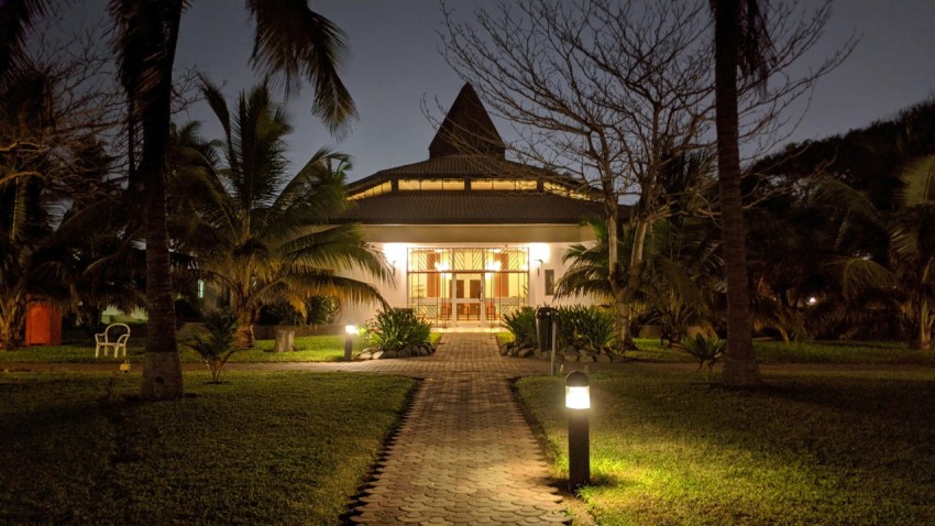 brown and white house surrounded by trees during night time