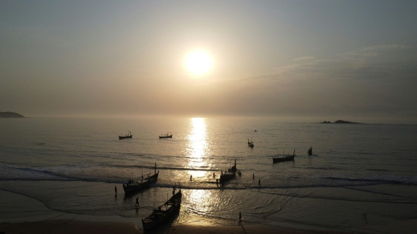 a group of boats floating on top of a body of water