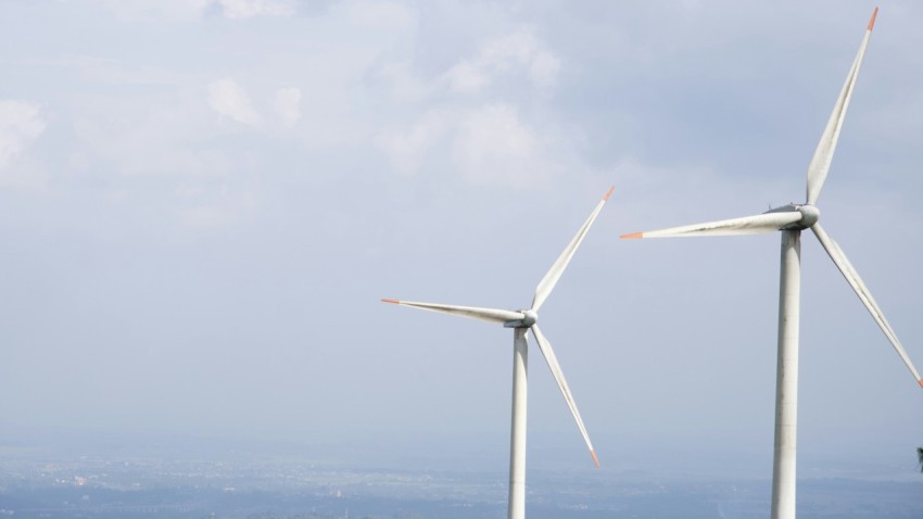 a couple of windmills that are next to each other 0Xg