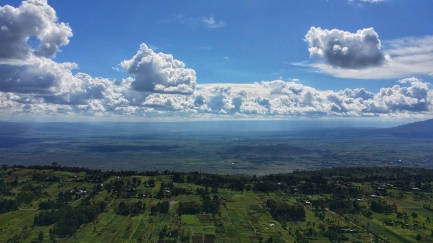 green grass field under blue sky and white clouds during daytime 4Du