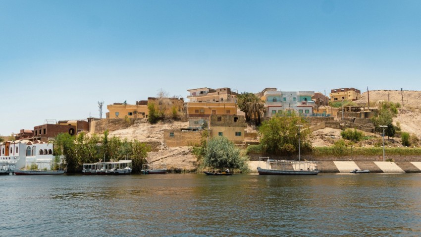 a body of water with boats and a hill in the background