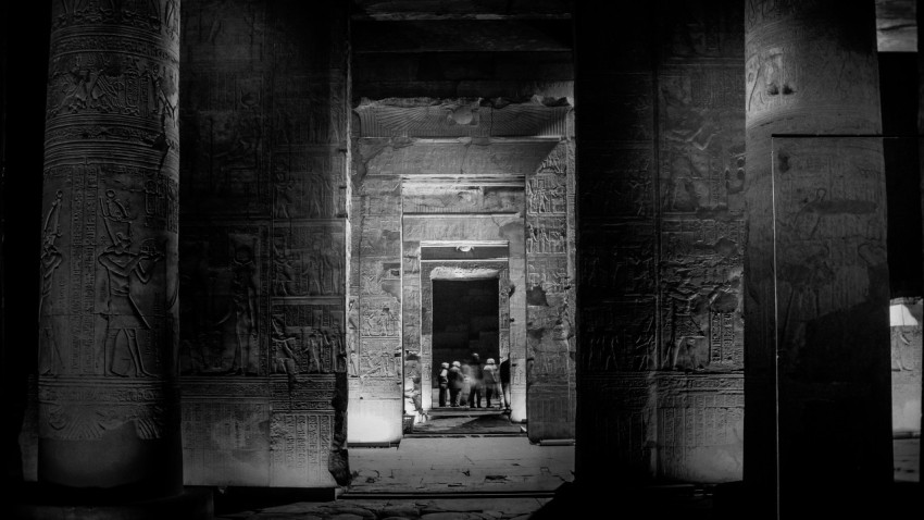 a black and white photo of some people in a doorway