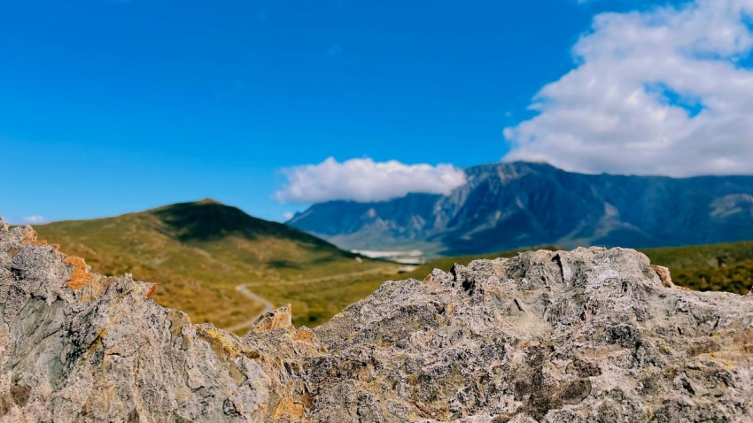 a view of a mountain range from a rocky outcropping