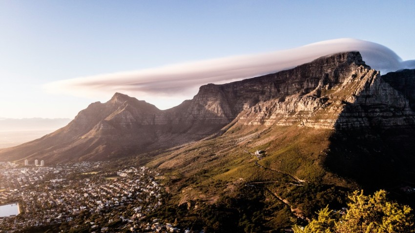 a mountain with a large cloud hovering over it