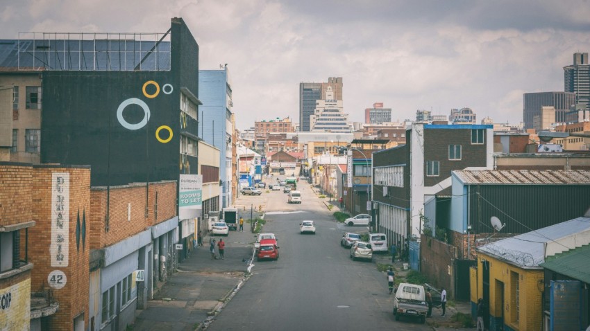 a city street with cars parked on both sides I