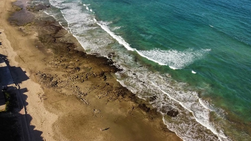 a birds eye view of a beach and ocean