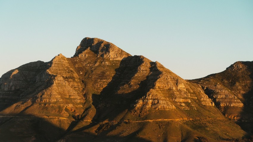 a very tall mountain with a sky in the background