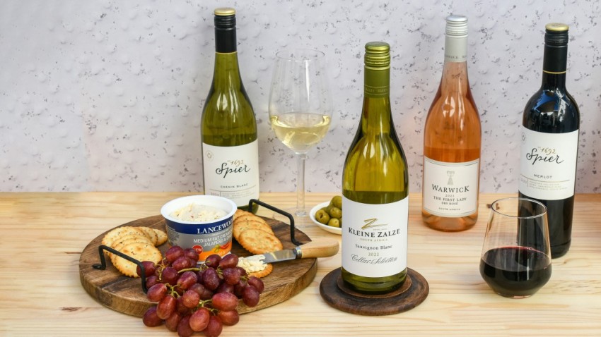 a wooden table topped with bottles of wine and glasses of wine 8leSts