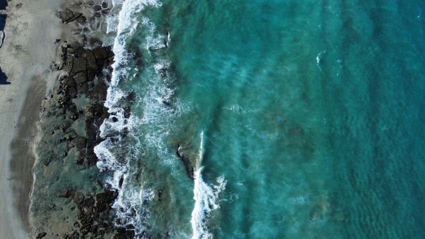 a birds eye view of a beach and ocean H