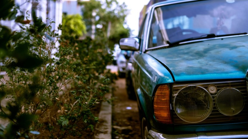 green car parked on the side of the road