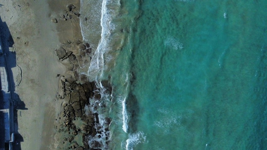 a birds eye view of a beach and ocean