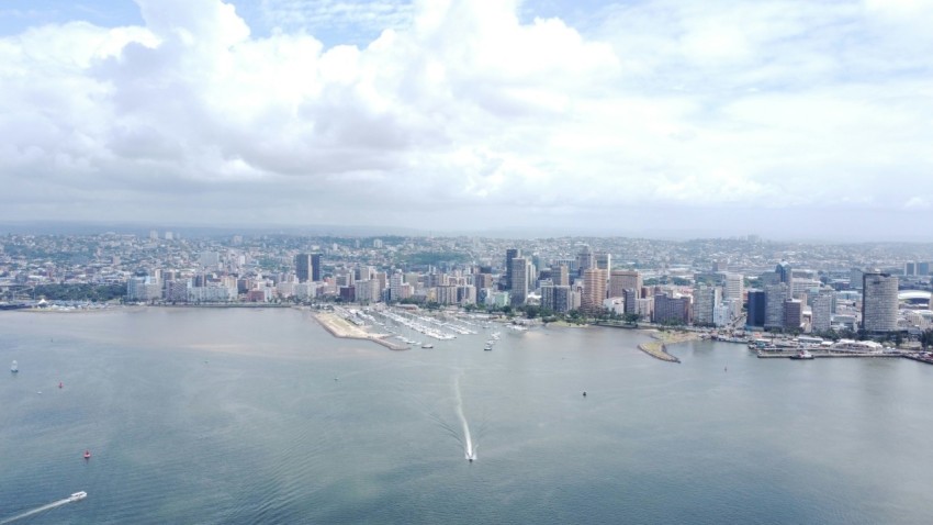 a large body of water with a city in the background