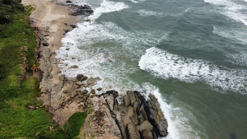 an aerial view of a beach and ocean