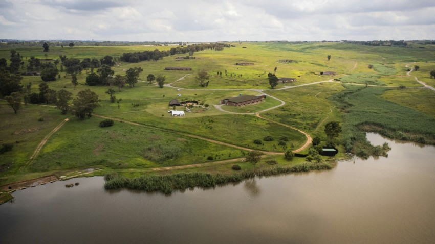 an aerial view of a farm and a lake