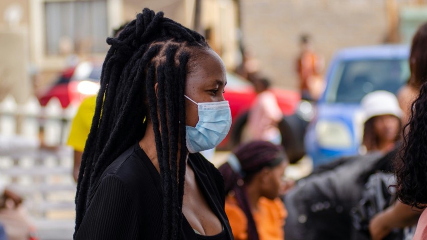 a woman wearing a face mask in a crowd of people