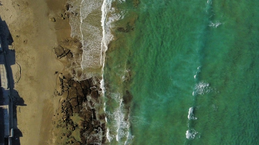 a birds eye view of a beach and ocean