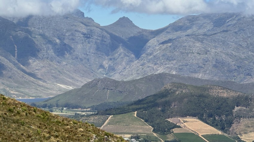 a view of a valley with mountains in the background 55YVVqs8