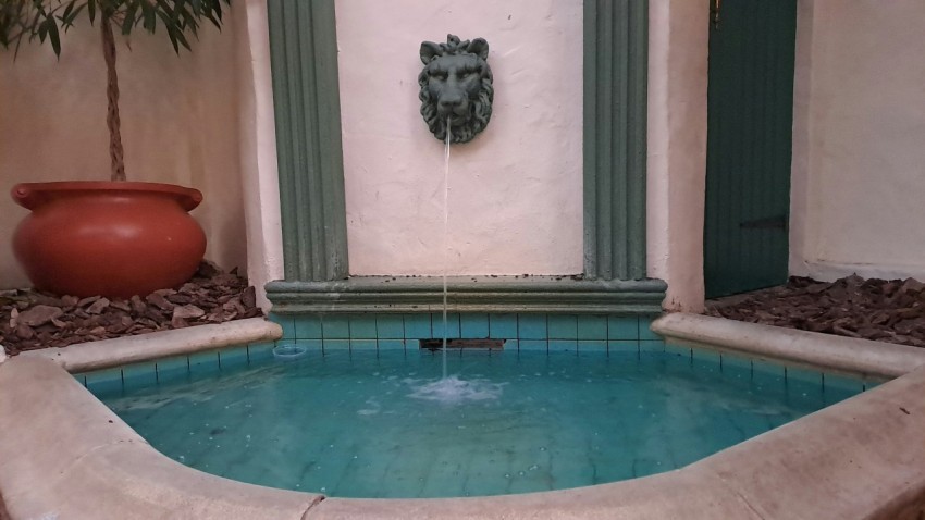 a fountain with a face on the side of it