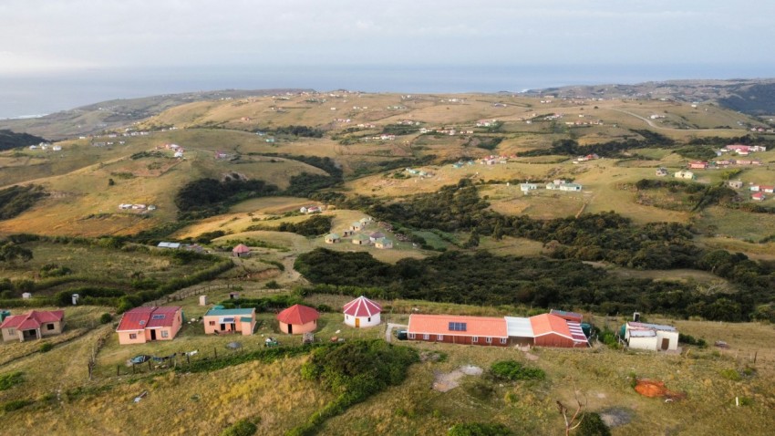 aerial view of houses on green grass field during daytime hiKRUjtL