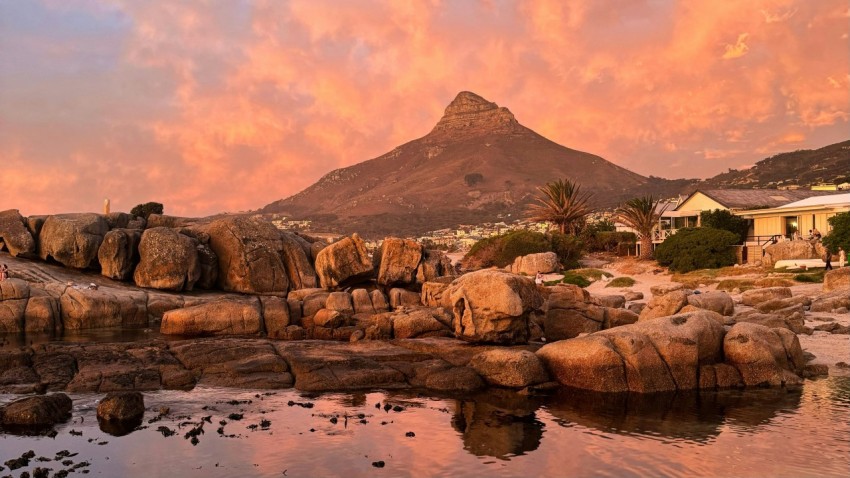 a rocky beach with a mountain in the background 6ycah