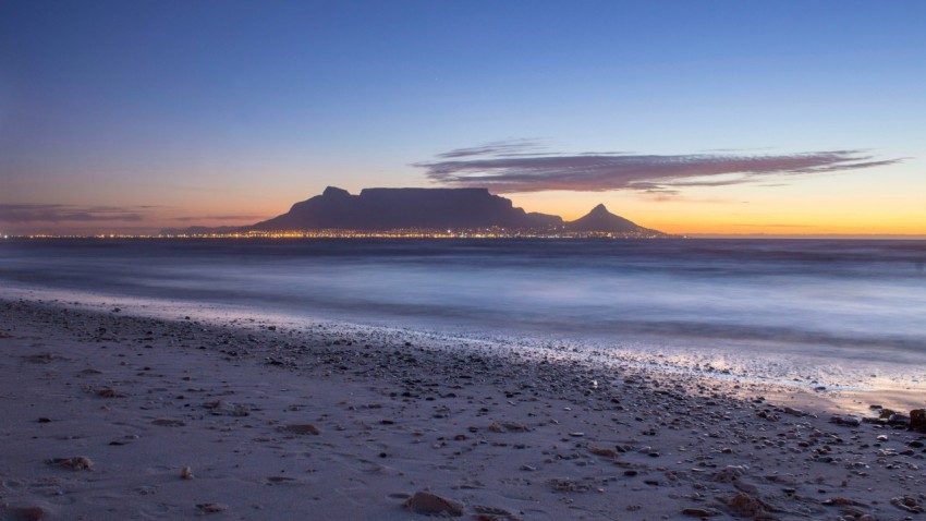 a beach with a mountain in the background