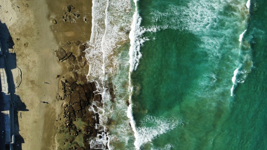 a birds eye view of a beach and ocean