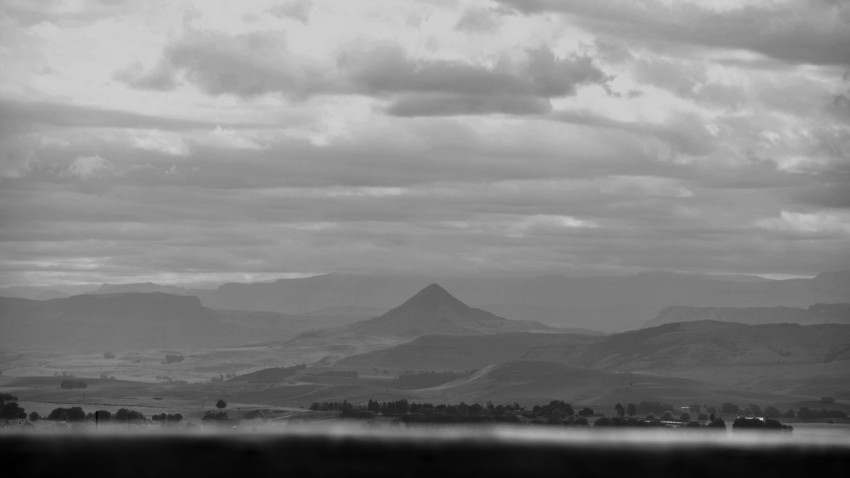 a black and white photo of a mountain range