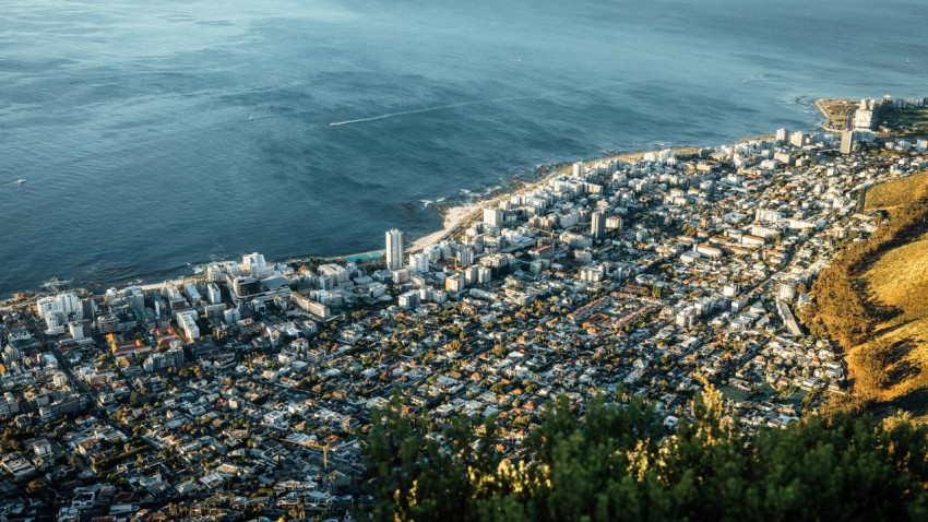 an aerial view of a city next to the ocean