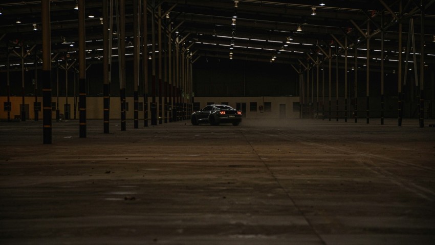 a car is parked in an empty warehouse