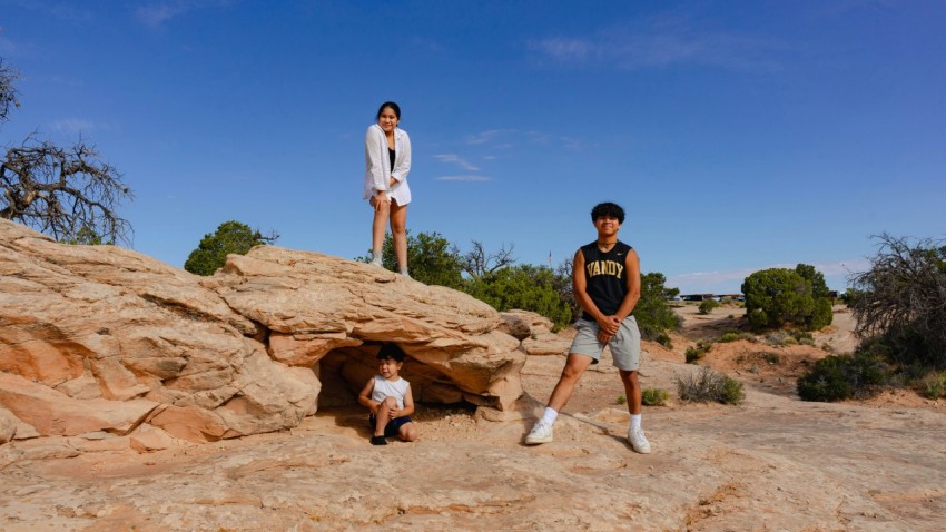 a couple of people that are standing on a rock