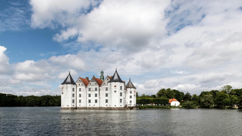 a large white building sitting on top of a lake