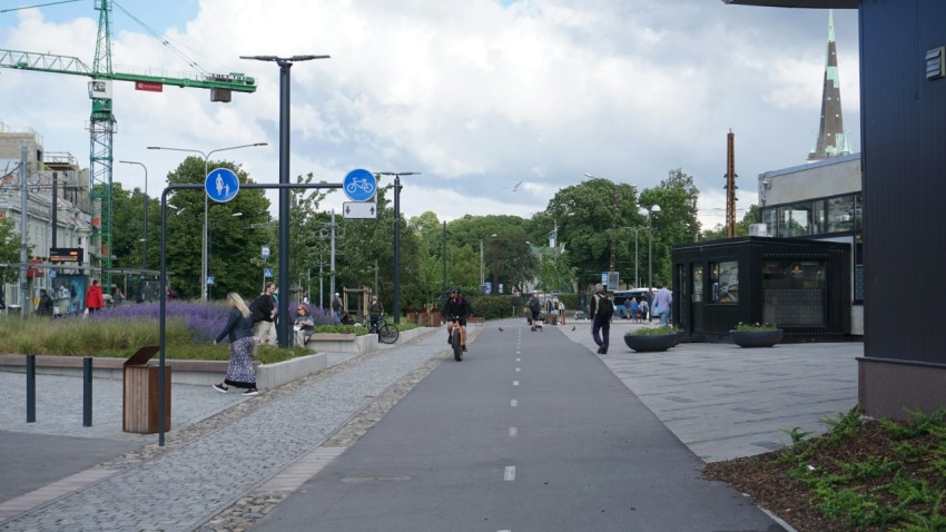 a city street with people walking on the sidewalk