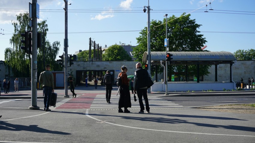 a group of people walking across a street