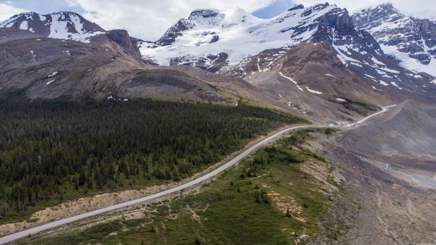 an aerial view of a road in the mountains