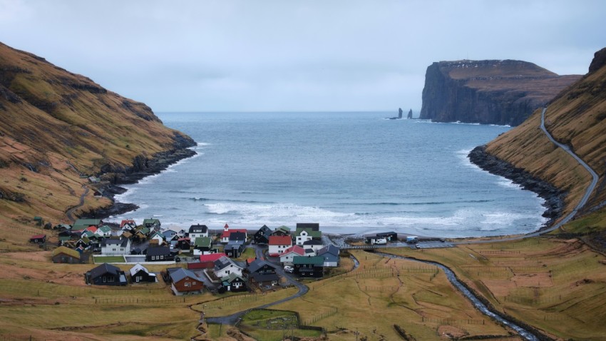 an aerial view of a small town by the ocean obxF